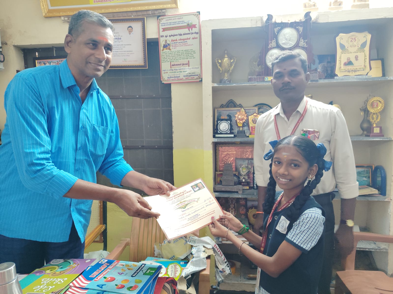 A student receiving a certificate from a teacher